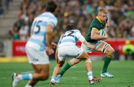 South Africa flanker Pieter-Steph du Toit (R) charges toward the Argentina try-line in Mbombela.