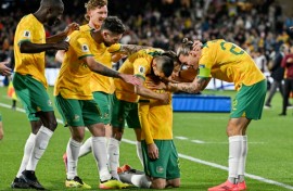 Australia's Craig Goodwin (kneeling) celebrates scoring against China 