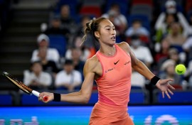 China's Zheng Qinwen hits a return to Italy's Jasmine Paolini during their women’s singles quater-final match at the Wuhan Open tennis tournament