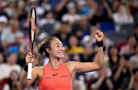 China's Zheng Qinwen celebrates after beating compatriot Wang Xinyu during their women's singles semi-final match at the Wuhan Open tennis tournament
