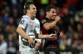 Joy: Antoine Dupont shares a joke with Clermont fly-half Benjamin Urdapilleta 