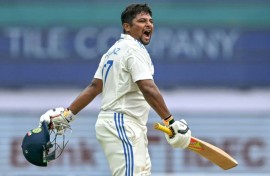 India's Sarfaraz Khan celebrates after scoring a century on the fourth day of the first cricket Test against New Zealand in Bengaluru