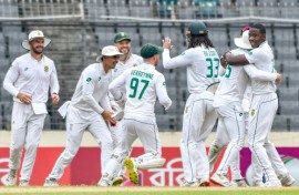 South Africa's Kagiso Rabada celebrates with teammates after taking a wicket