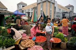 A vendor sells vegetables at a street market in Pyin Oo Lwin township, still in the hands of Myanmar's military