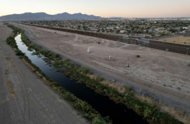 Vehicles guard the US side of the border with Mexico