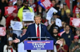 Republican presidential nominee Donald Trump holds a press conference from inside trash hauler at Green Bay Austin Straubel International Airport on October 30, 2024 in Green Bay, Wisconsin