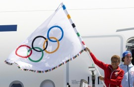 Los Angeles Mayor Karen Bass, whose city will host the 2028 Summer Games, holds the five-ringed Olympic banner