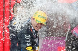 Champagne moment: Max Verstappen celebrates victory on the podium