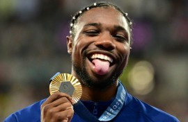 Noah Lyles with his Olympic 100m gold medal - but it wasn't enough to earn him a chance to win the men's track athlete of the year award