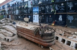 This picture taken on November 1, 2024 shows a coffin covered in mud and debris at a cemetery in the town of Alfafar