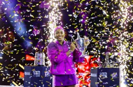 Coco Gauff poses with the trophy after defeating China's Zheng Qinwen to win the WTA Finals title