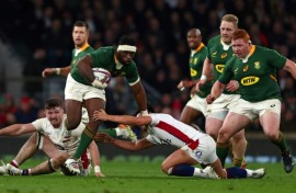 South Africa's Siya Kolisi avoids a tackle from England fly-half Marcus Smith at Twickenham in 2021