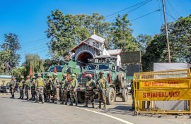 Army personnel stand guard Tuesday during a curfew in Imphal, in India's northeastern state of Manipur