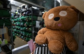 A teddy bear sits amongst thousands of items -- all bagged, tagged and organised based on where and when they were lost - at the Tokyo police department's lost and found centre
