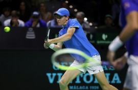 Jannik Sinner triumphed in singles and doubles to help Italy reach the Davis Cup semi-finals
