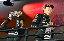 Las Vegas Grand Prix winner George Russell (R) is going to party with runner-up Mercedes teammate Lewis Hamilton (L) giving him a taste of what is to come