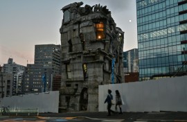Pedestrians walk past the four-storey Arimaston Building created by Japanese architect Keisuke Oka in Tokyo