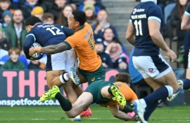 Key score: Scotland's captain Sione Tuipulotu (L) runs to the line to score the first try of a one-off Test against Australia at Murrayfield