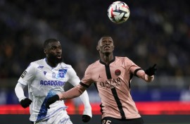 Paris Saint-Germain's Nuno Mendes (R) holds off Lassine Sinayoko of Auxerre during Friday's goalless draw in Ligue 1
