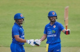 Darwish Rasooli (R) celebrates with Gulbadin Naib after scoring his first fifty for Afghanistan in a Twenty20 international against Zimbabwe in Harare on December 13.
