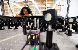 Experimental physicist Daniela Angulo poses with an apparatus in the physics lab at the University of Toronto