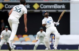 India's Virat Kohli (R) faces a bouncer from Australia's Mitchell Starc