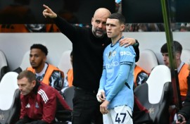 Manchester City manager Pep Guardiola speaks with Phil Foden