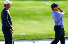 Tiger Woods, left, watches son Charlie practice ahead of the weekend's 36-hole PNC Championship for parent and child pairs