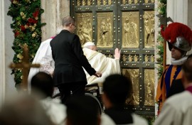 Pope Francis opens the Holy Door of St Peter's Basilica during a ceremony to mark the launch of Jubilee 2025