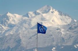 The WMO flag flies on top of its headquarters in Geneva, in front of the Mont Blanc massif