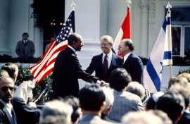 US President Jimmy Carter (C) congratulates Egyptian President Anwar al-Sadat (L) and Israeli Prime Minister Menachem Begin (R) on March 26, 1979 on the north lawn of the White House after the signing of a historic peace treaty