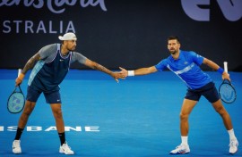Australia’s Nick Kyrgios (L) and Serbia’s Novak Djokovic (R) lost in the doubles at the Brisbane Interational