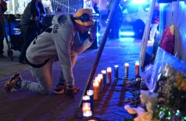 A mourner reacts at a memorial on New Orlean's Bourbon Street on January 2, 2025 one day after a man drove a truck into the crowded street, killing 14 people