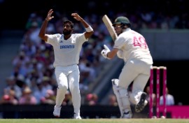 India’s captain Jasprit Bumrah (L) reacts after Australia’s Steve Smith hit a shot during day two of the fifth Test