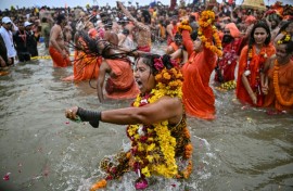 Sadhvis or Hindu holy women take part in a mass bathing ritual in Sangam