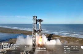 In this screen grab taken from the SpaceX broadcast the Starship's Super Heavy Booster is grappled mid-air as it returns to the launch pad at Starbase near Boca Chica, Texas, on January 16, 2025
