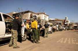 Private firefighters stand watch at property opwned by billionaire developer Rick Caruso