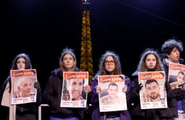 Some of those present carried photos of the hostages under a sign saying 'abducted'