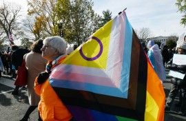 People hold LGBTQ+ flags outside the US Supreme Court