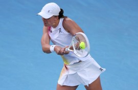 Poland's Iga Swiatek hits a return against Germany's Eva Lys 