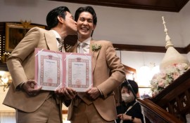 Thai actors Apiwat 'Porsch' Apiwatsayree (L) and Sappanyoo 'Arm' Panatkool pose after registering their same-sex marriage Thursday