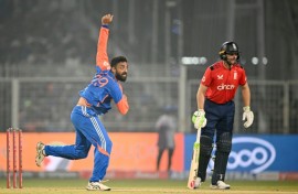 India's Varun Chakravarthy (L) took three wickets, including the crucial scalp of Jos Buttler (R)