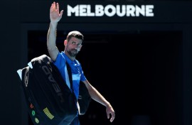 All over: Novak Djokovic exits the court after retiring from the Australian Open semi-final against Alexander Zverev
