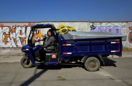 Marco Antonio Terron and his daughter Maria del Mar ride their three-wheeled scrap collection vehicle near Mexico City