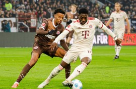 Bayern Munich defender Alphonso Davies, R, has signed a five-year extension with the club.