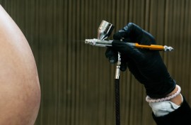 An employee paints on a fake pregnant belly made for cinema and television created by Cinebebe in Paris