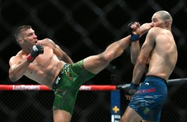 South Africa's Dricus du Plessis (L) and Sean Strickland exchange blows in the UFC middleweight title bout