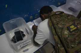 A student leaves his cellphone at the beginning of the school day at Reverend Martin Luther King public school in Rio de Janeiro