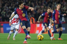Robert Lewandowski converts the penalty that gave Barcelona victory over Rayo Vallecano and top spot in La Liga