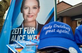 A poster of the Alternative for Germany's Alice Weidel and a 'Make Duisburg Great Again' cap at a stall of the far-rigth party in the western industrial town